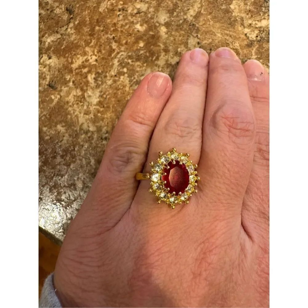 Woman’s vintage ring with golden with red gemstone